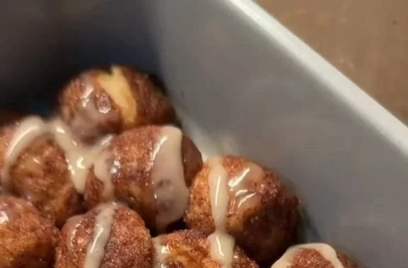 Delicious quick cinnamon roll bites topped with icing on a plate