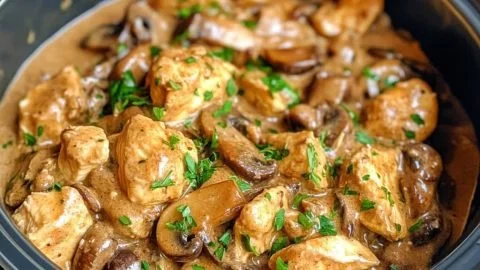 Slow Cooker Chicken Stroganoff served in a bowl with mushrooms and herbs.
