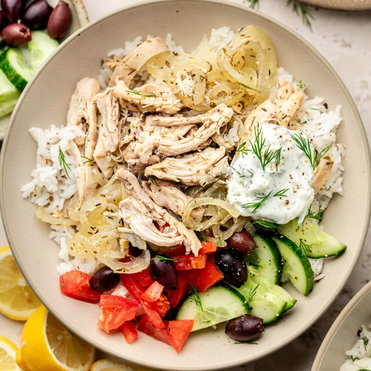 A delicious serving of slow cooker Greek chicken garnished with herbs and lemon