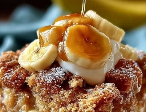 Delicious Southern Banana Cobbler topped with whipped cream and bananas