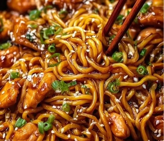 Delicious sticky garlic chicken noodles served in a bowl
