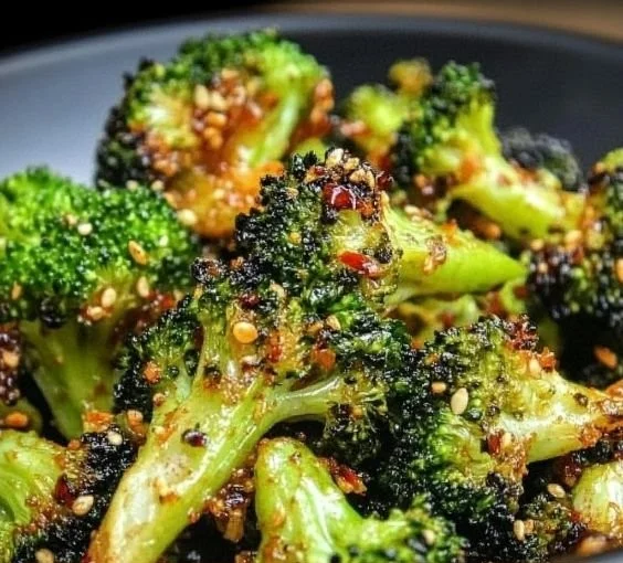 Sweet Chili Roasted Broccoli dish garnished with sesame seeds and chili flakes
