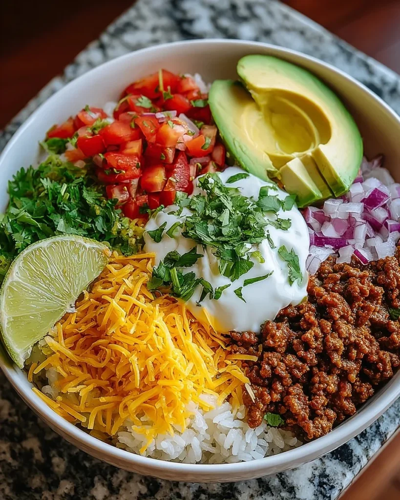 Delicious Taco Rice Bowl topped with fresh ingredients and spices.