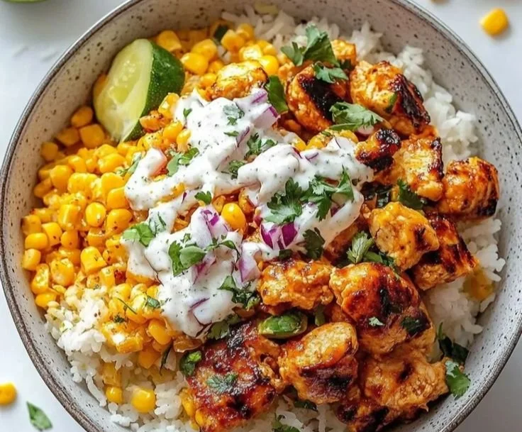 Vibrant chicken rice bowl with colorful vegetables and tender chicken slices.