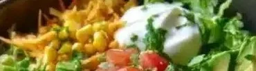 Delicious enchilada chicken bowl topped with fresh ingredients.
