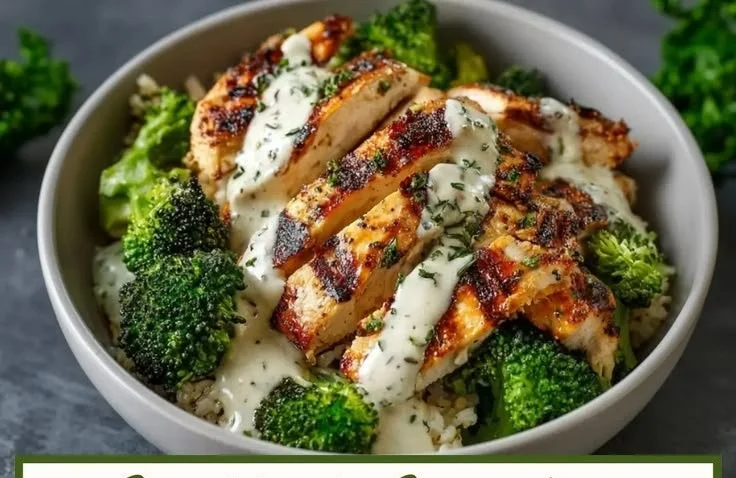 Grilled chicken broccoli bowl with creamy garlic sauce served in a bowl