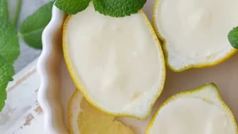 Delicious lemon possets presented in vibrant lemon shells.