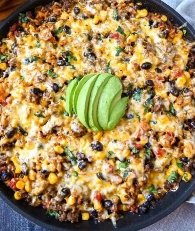 Delicious cheesy taco rice skillet ready to serve, showcasing vibrant ingredients